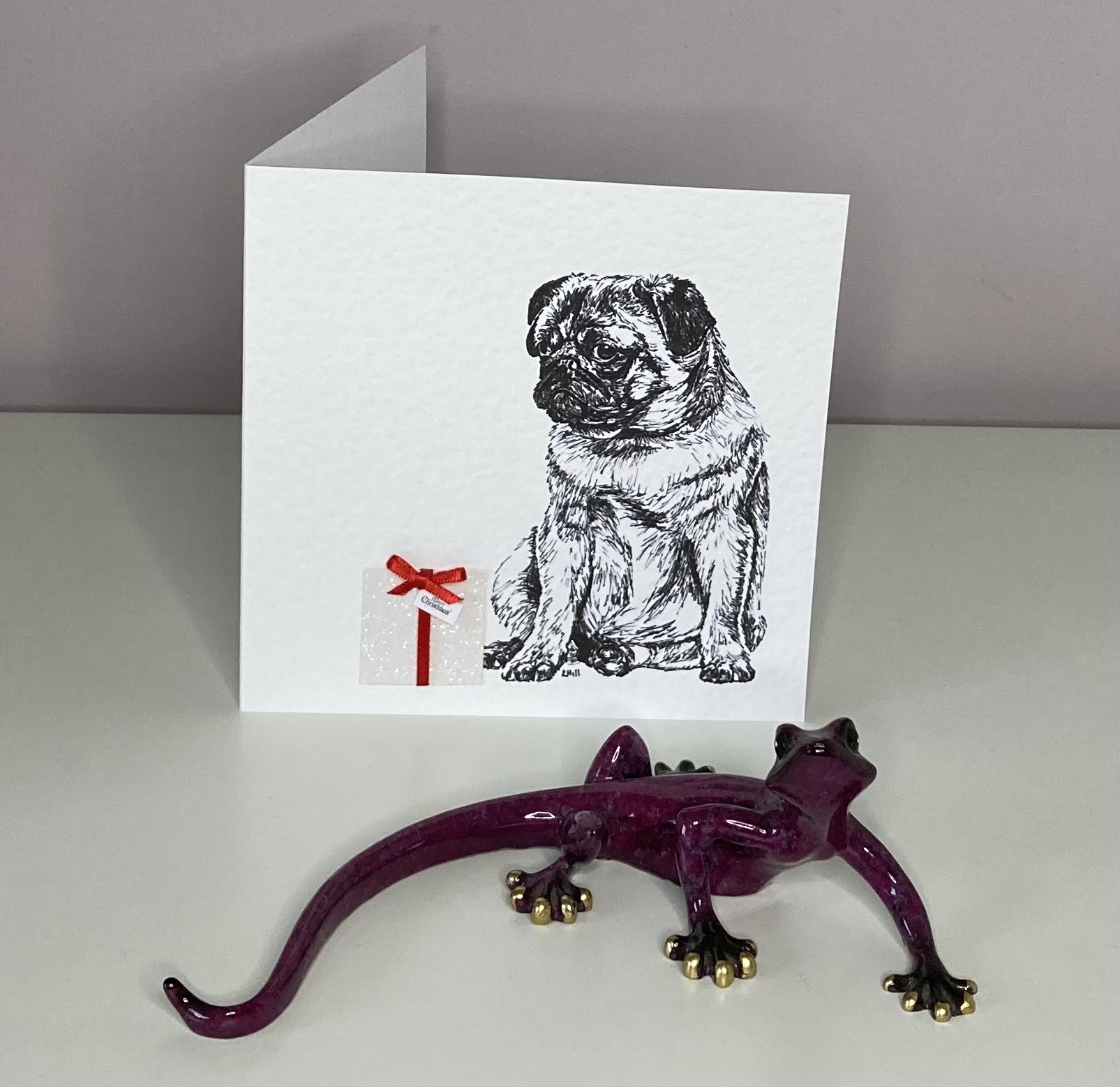 Pug with Christmas present Christmas card by Louisa Hill