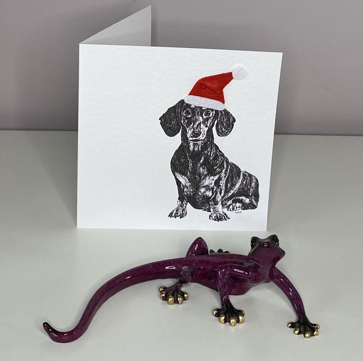 Dachshund in Santa hat Christmas cards by Louisa Hill