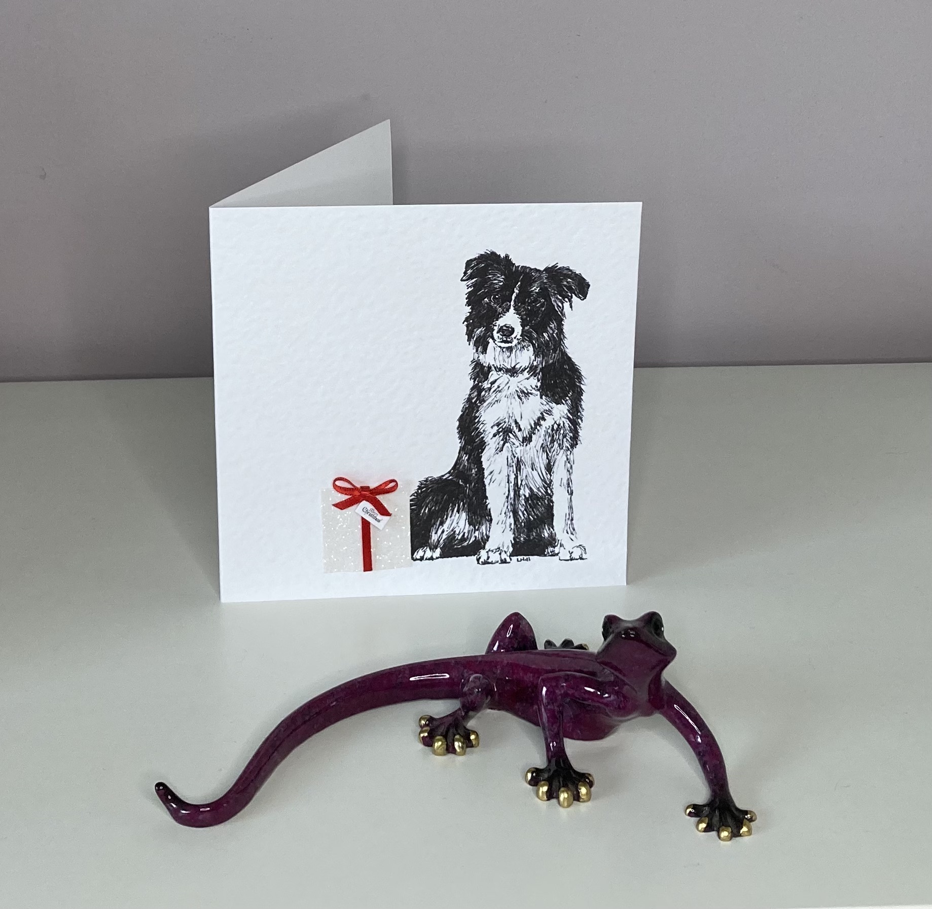 Border Collie with Christmas present Christmas card by Louisa Hill