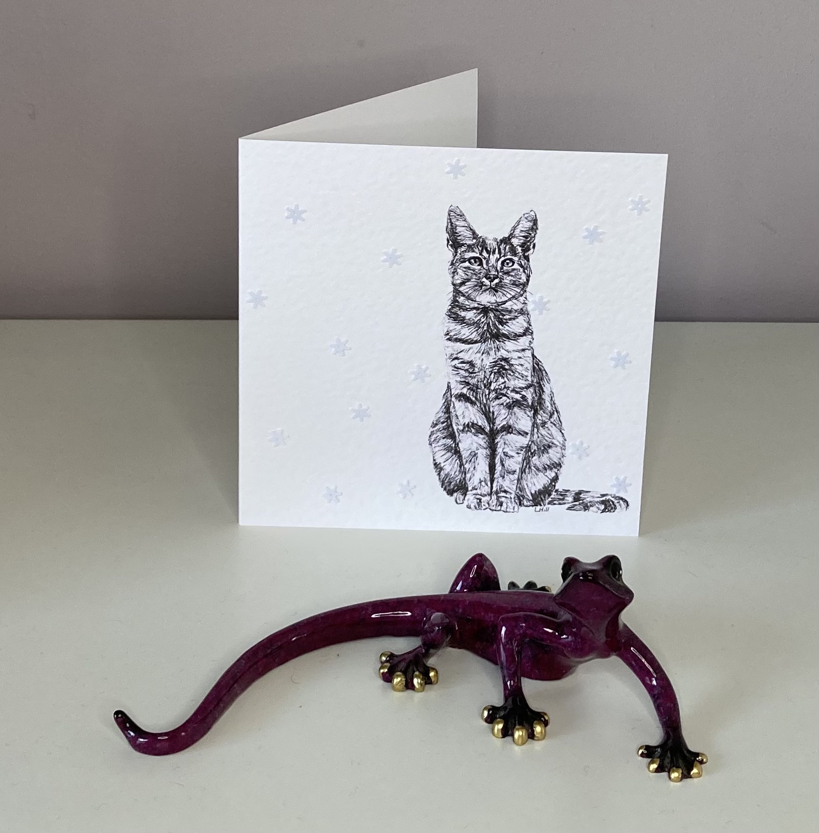 Tabby with snowflakes Christmas card by Louisa Hill