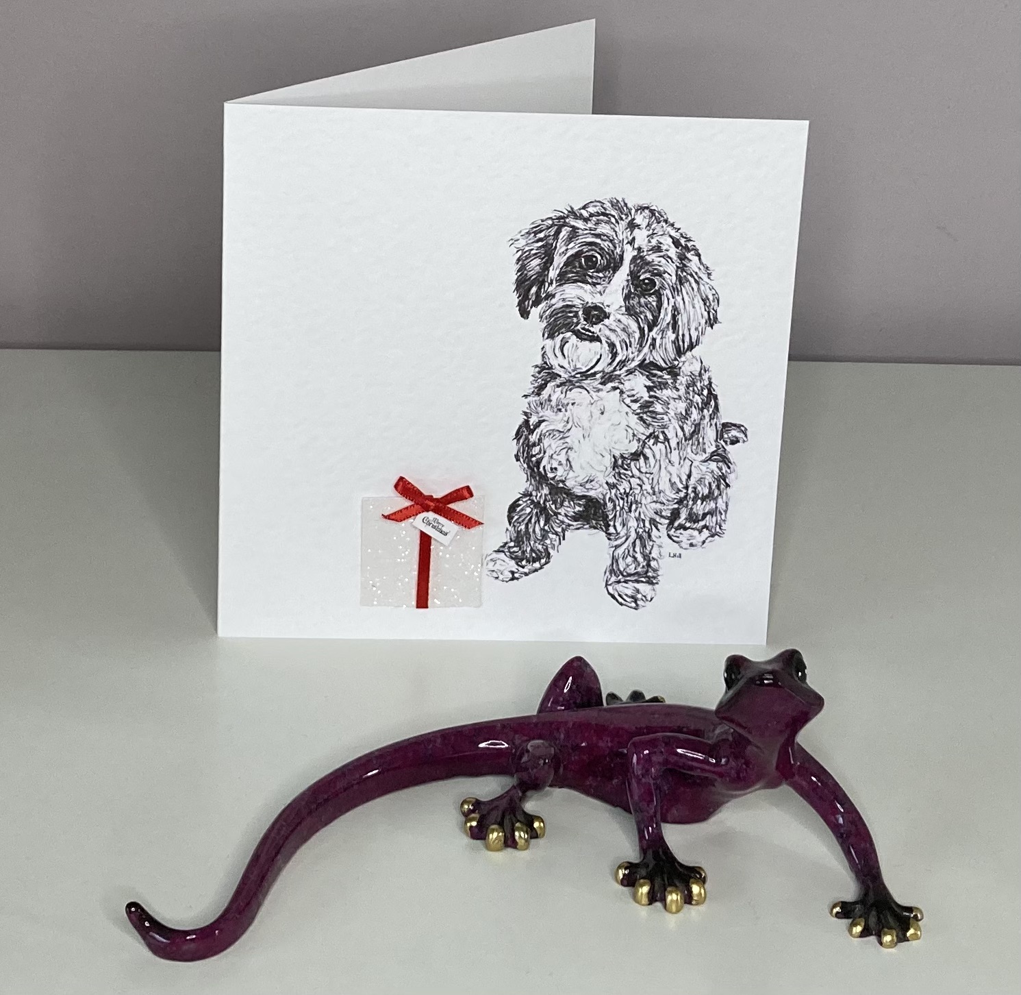 Cavapoo with Christmas present Christmas card by Louisa Hill