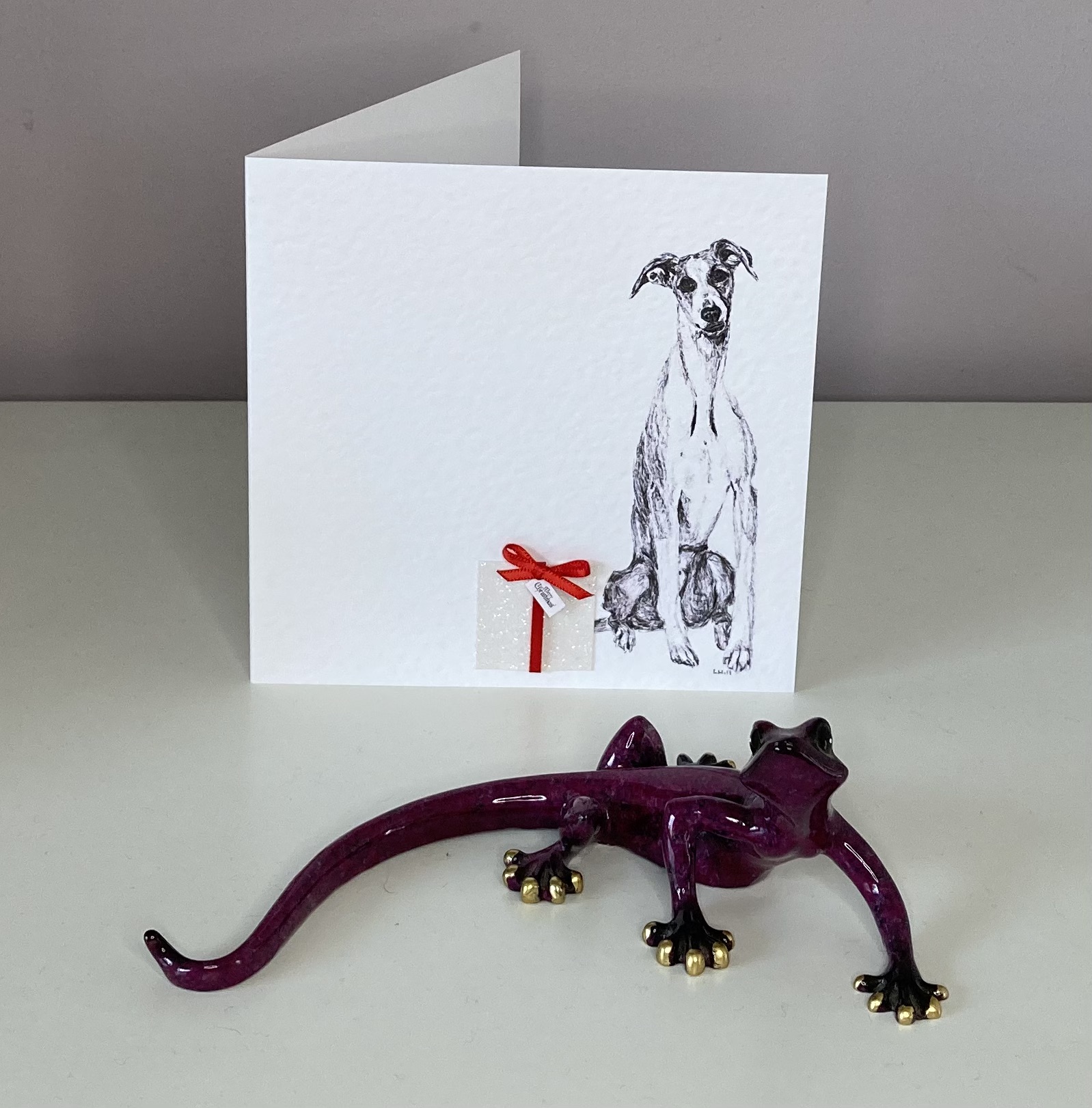 Whippet with Christmas present Christmas card by Louisa Hill