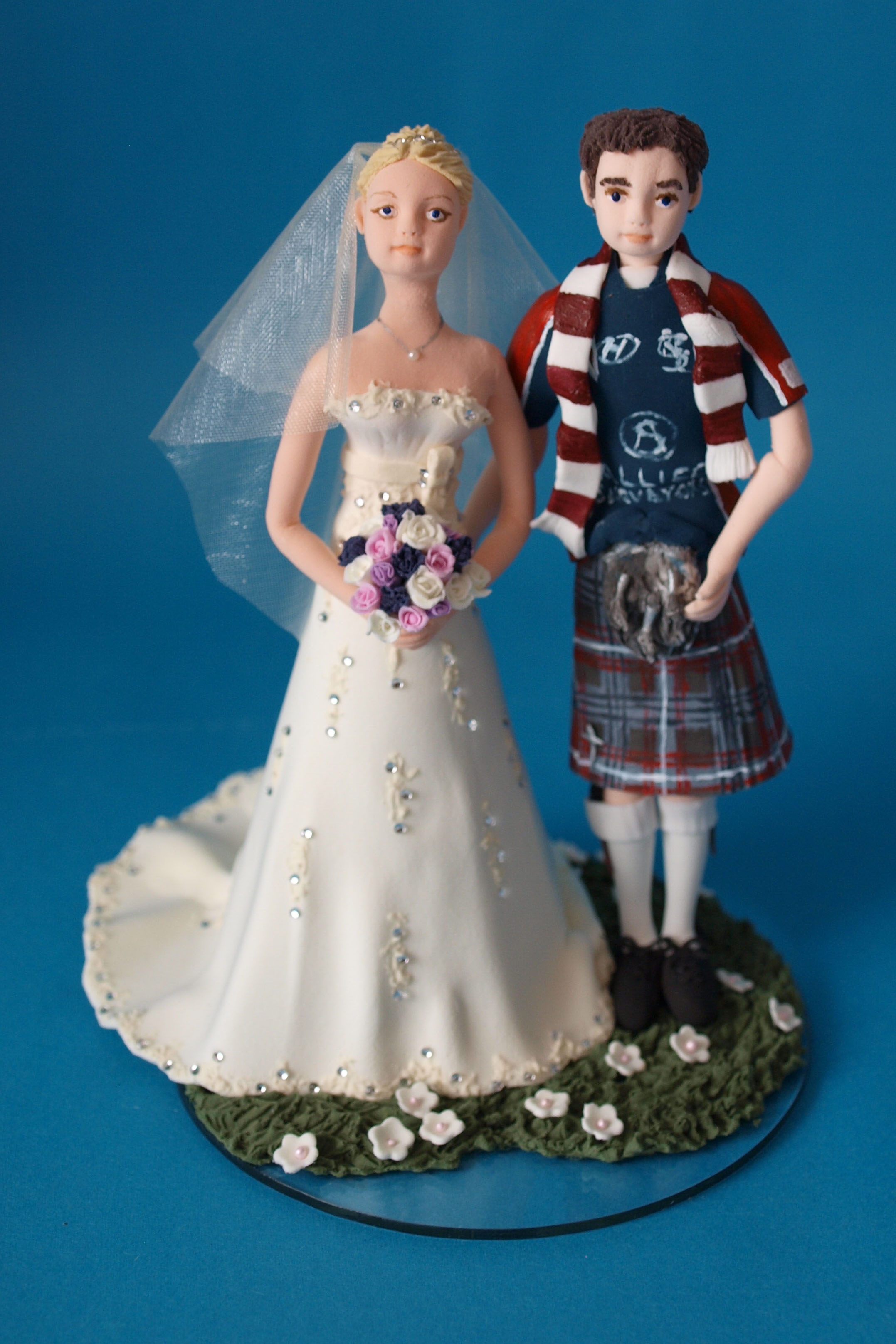 Scottish bride and groom in kilt and rugby shirt wedding cake topper by Louisa Hill