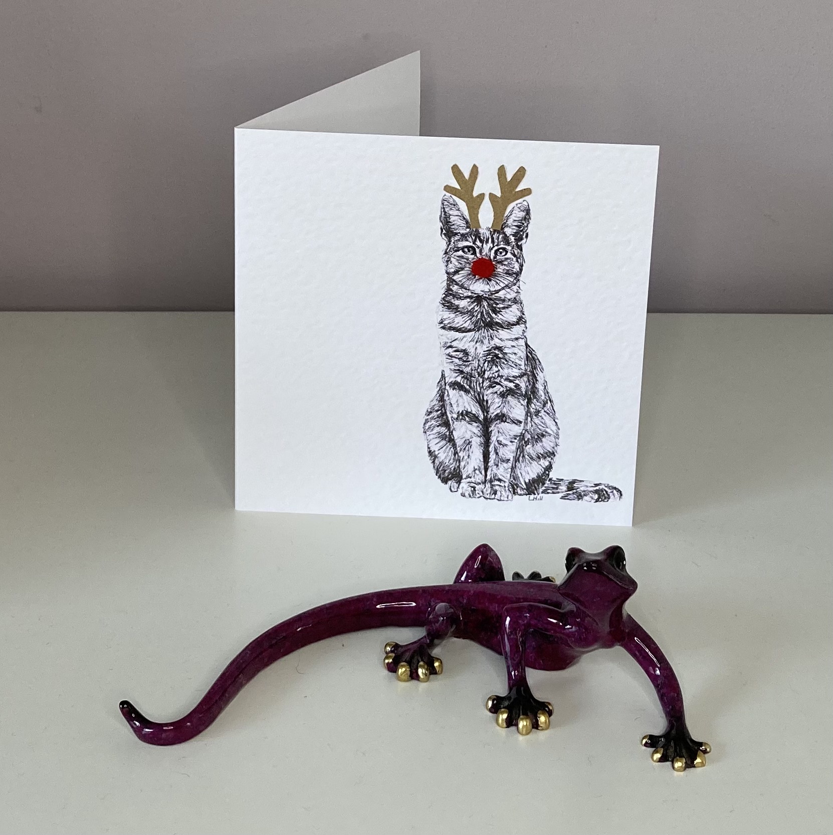 Tabby with reindeer antlers and red nose Christmas card by Louisa Hill