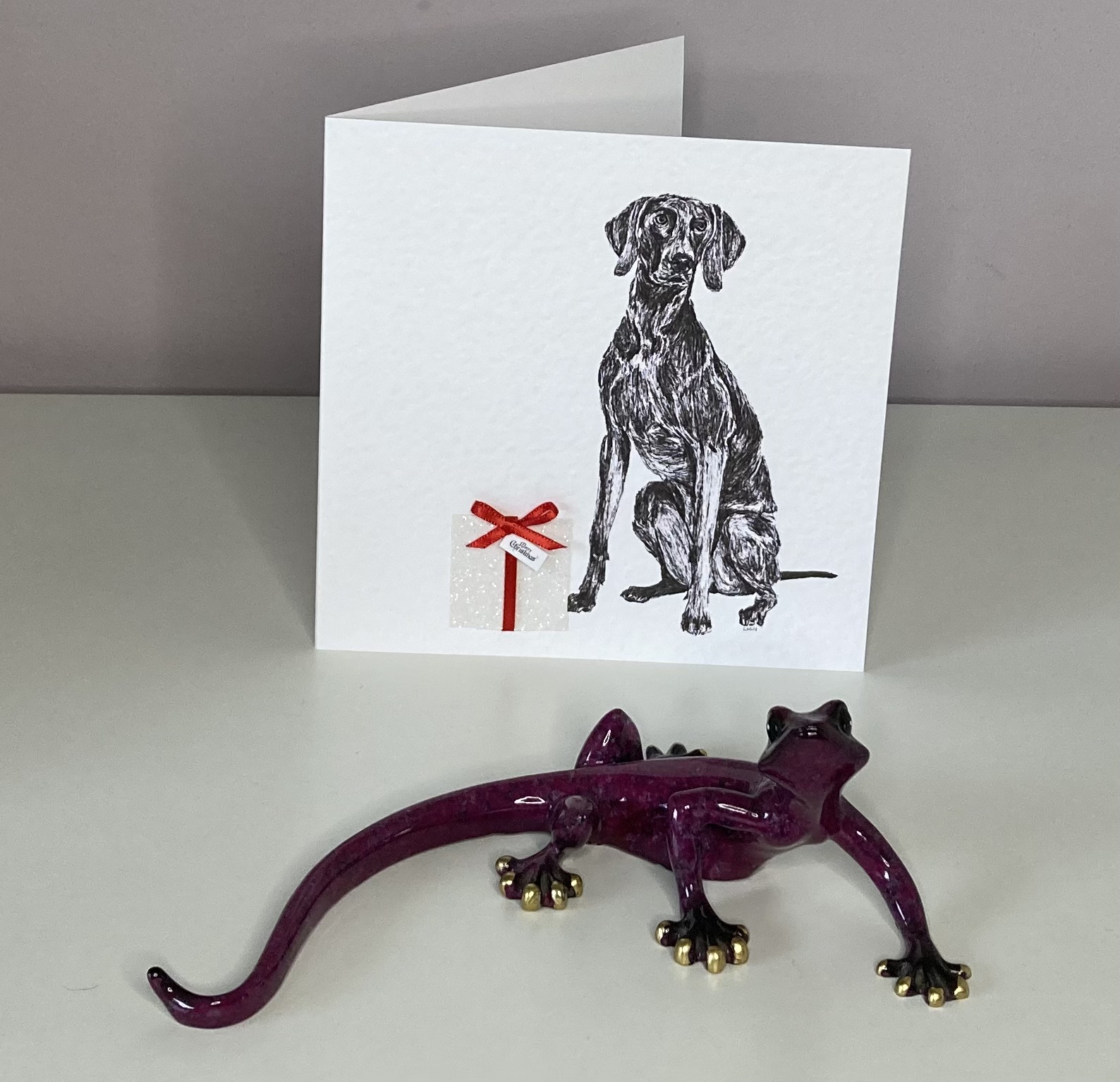 Weimaraner with Christmas present Christmas card by Louisa Hill