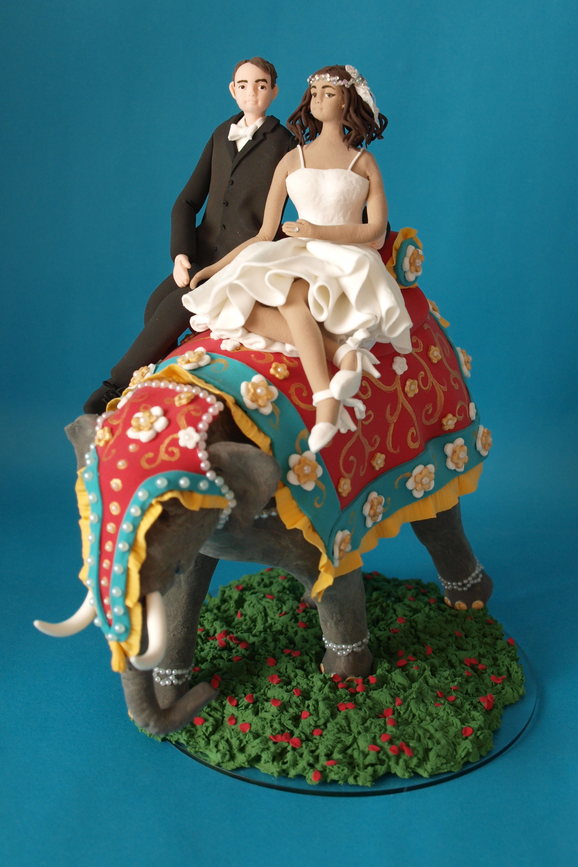 Bride and groom with elephant wedding cake topper with cats by Louisa Hill