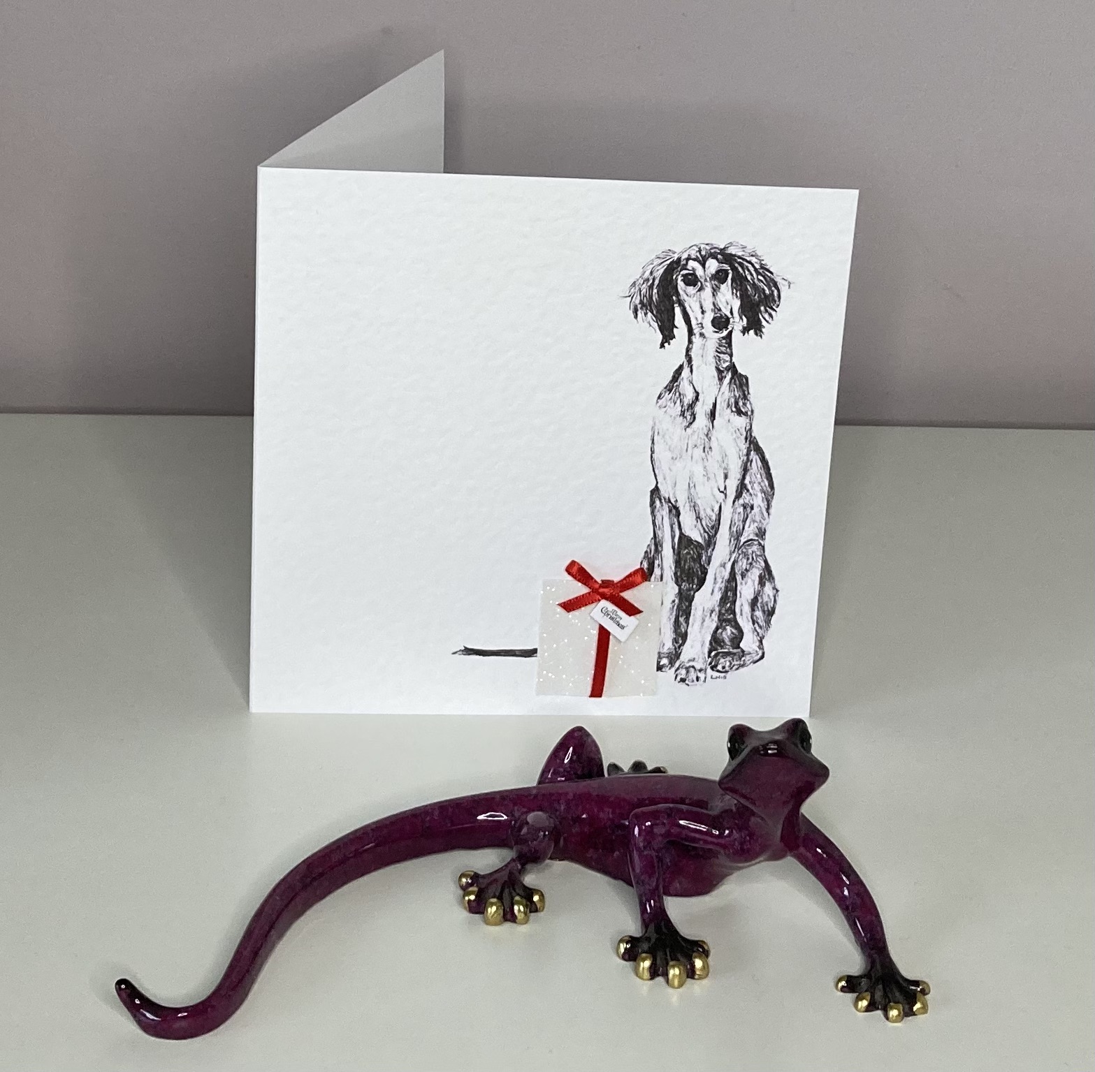 Saluki with Christmas present Christmas card by Louisa Hill