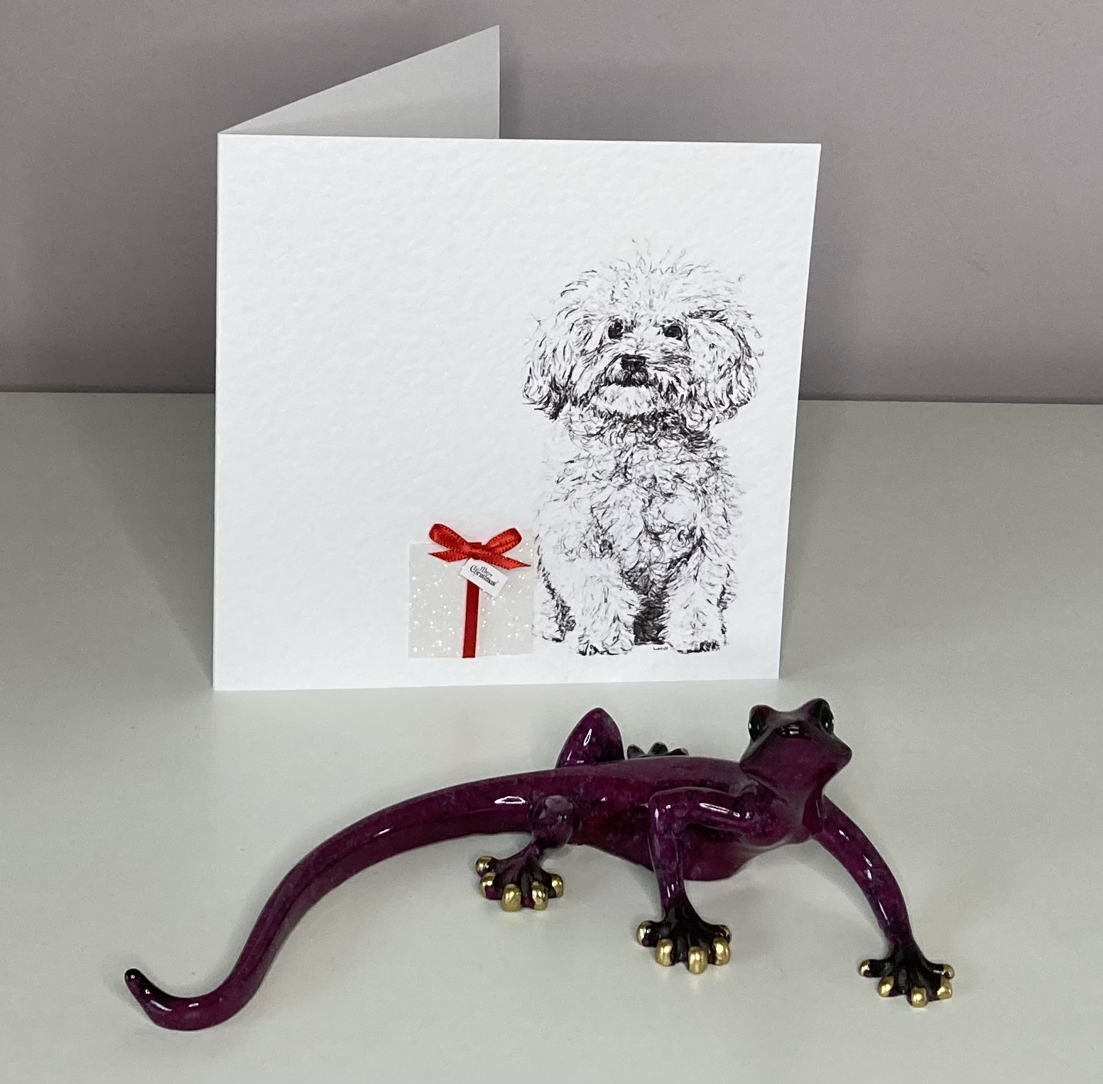 Bichon Frise with Christmas present Christmas card by Louisa Hill