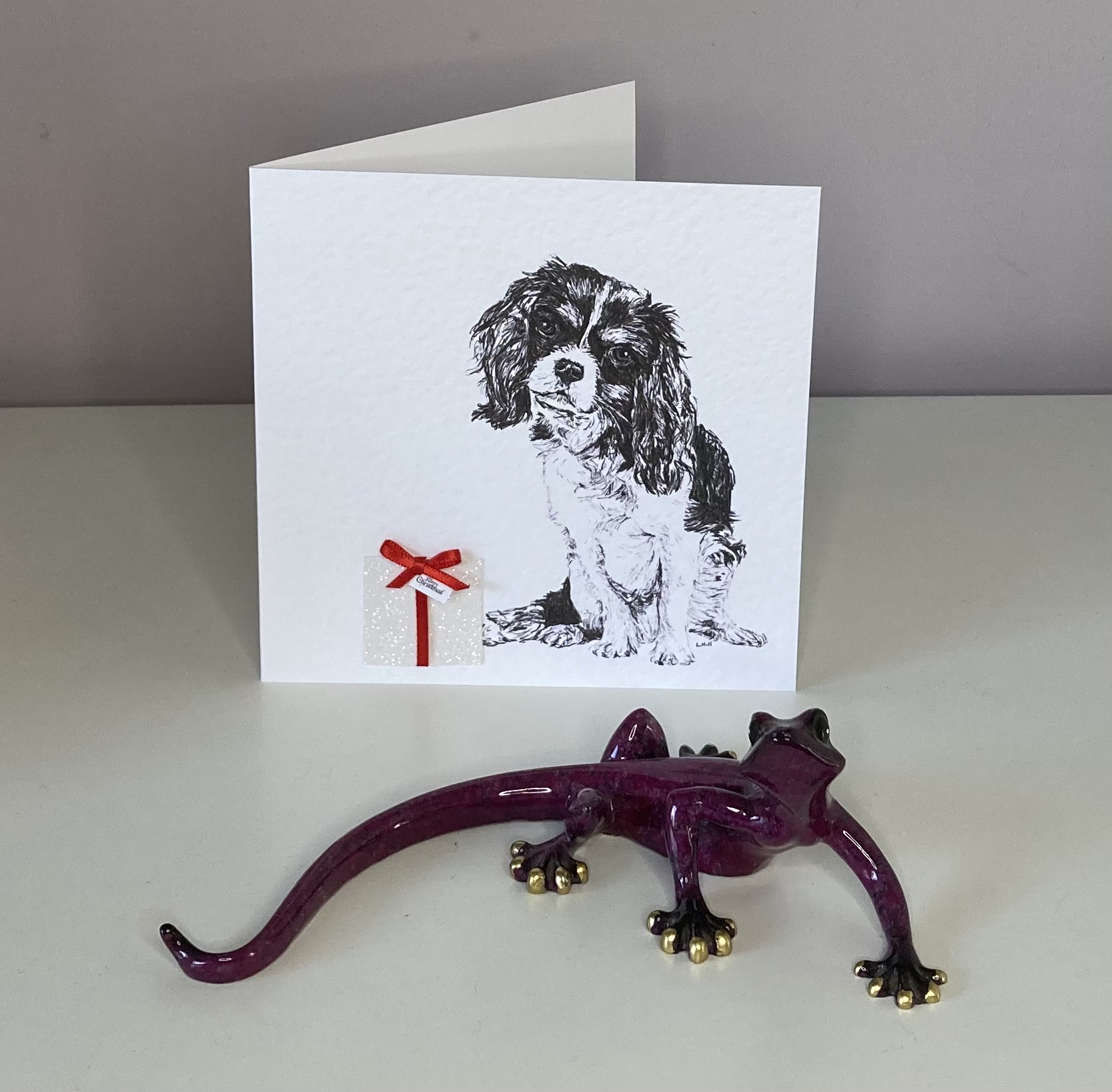 Cavalier King Charles Spaniel with Christmas present Christmas card by Louisa Hill