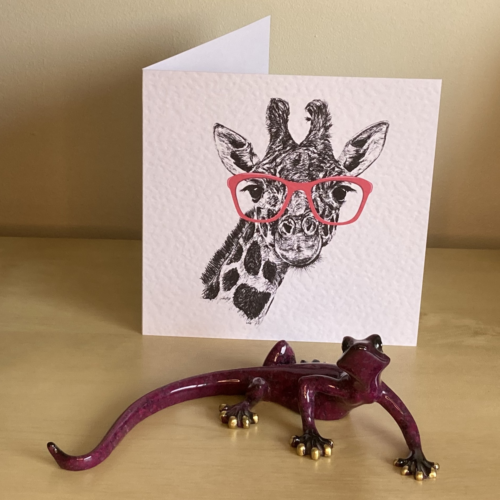 Giraffe pen and ink illustration with pink glasses by Louisa Hill