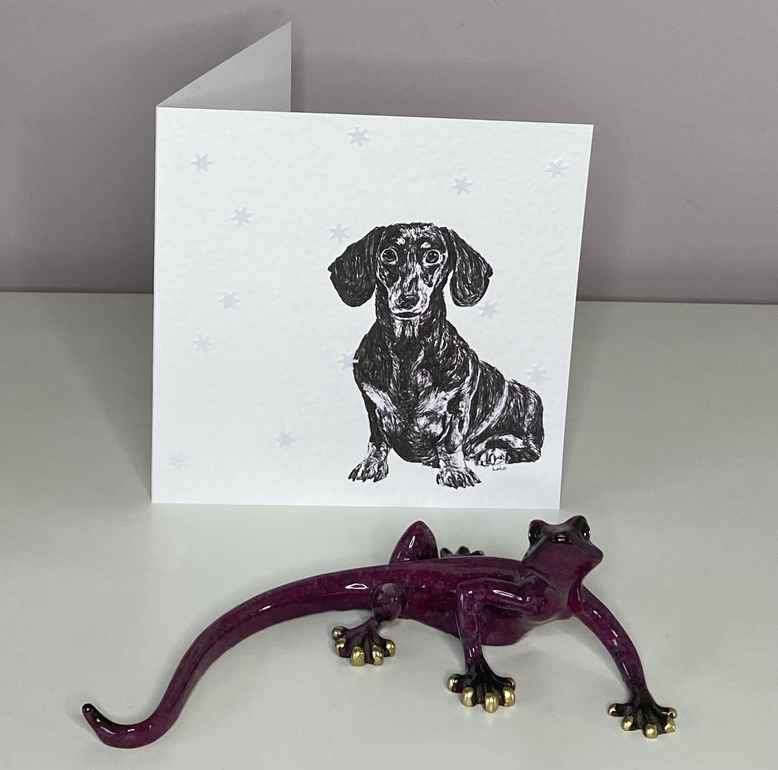 Dachshund in snowflakes Christmas cards by Louisa Hill