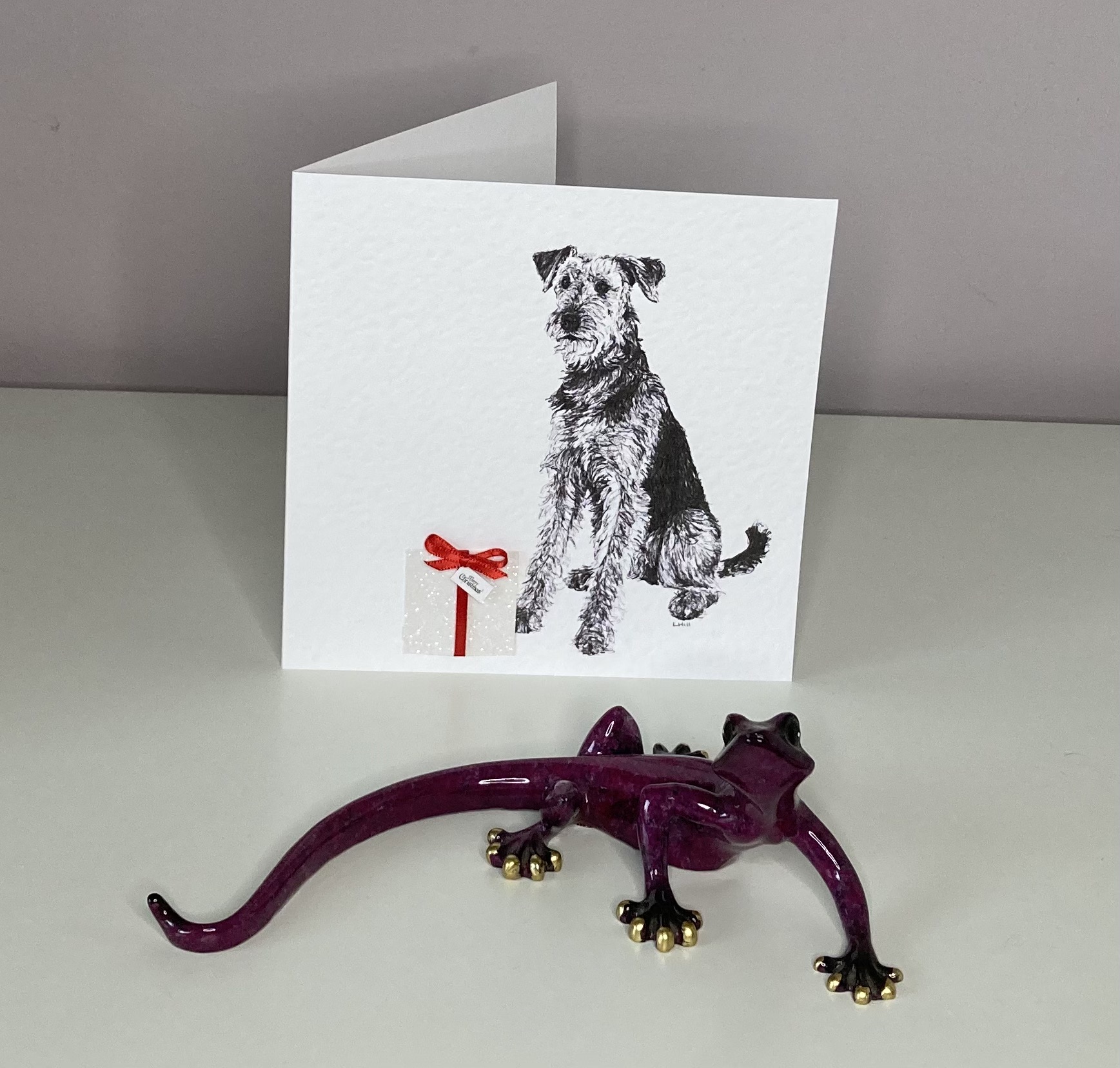 Airedale Terrier with Christmas present Christmas card by Louisa Hill